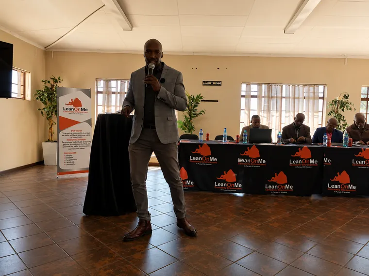Speaker addressing men at the Khuluma Ndoda campaign
