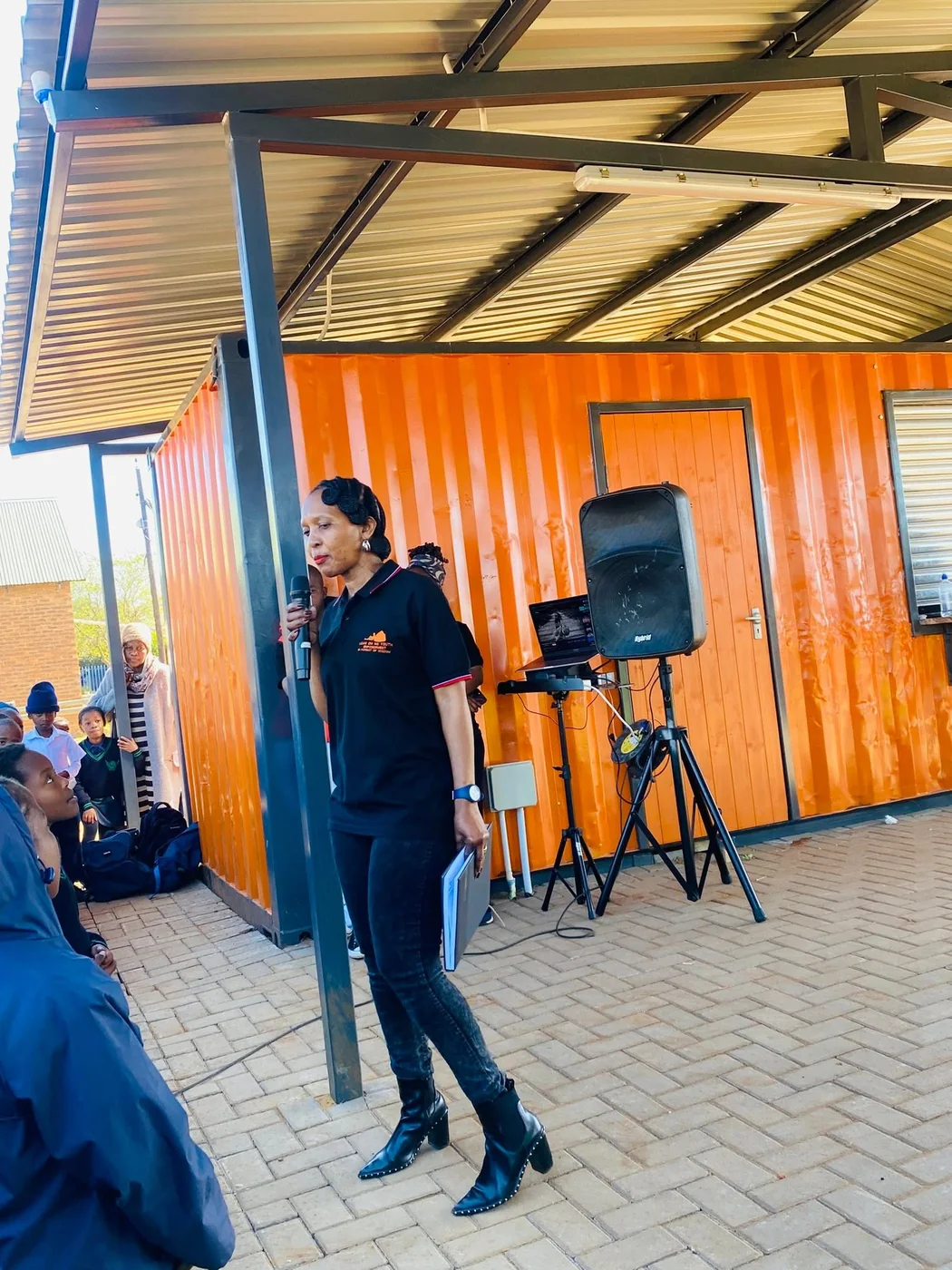 Linah Mnisi, founder of Lean On Me Community Empowerment, speaking at a community programme